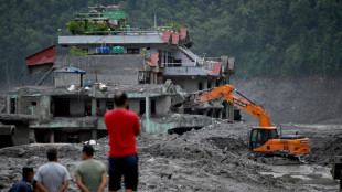 Nepal recovers bodies but presses on for trapped tunnel workers